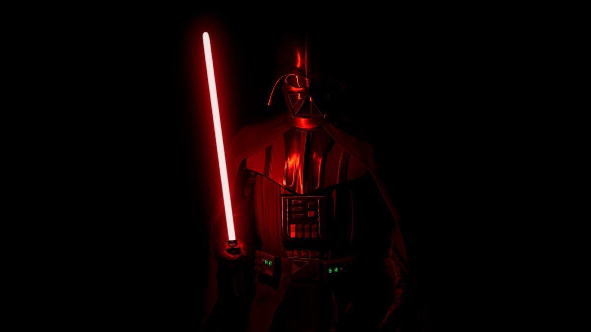 Dark Vador, debout dans une pièce d'un noir absolu éclairé par un sabre laser rouge.