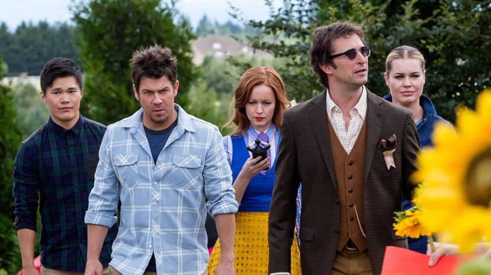 Les personnages principaux de The Librarians, l'un tenant un scanner de mains de style «Ghostbusters».