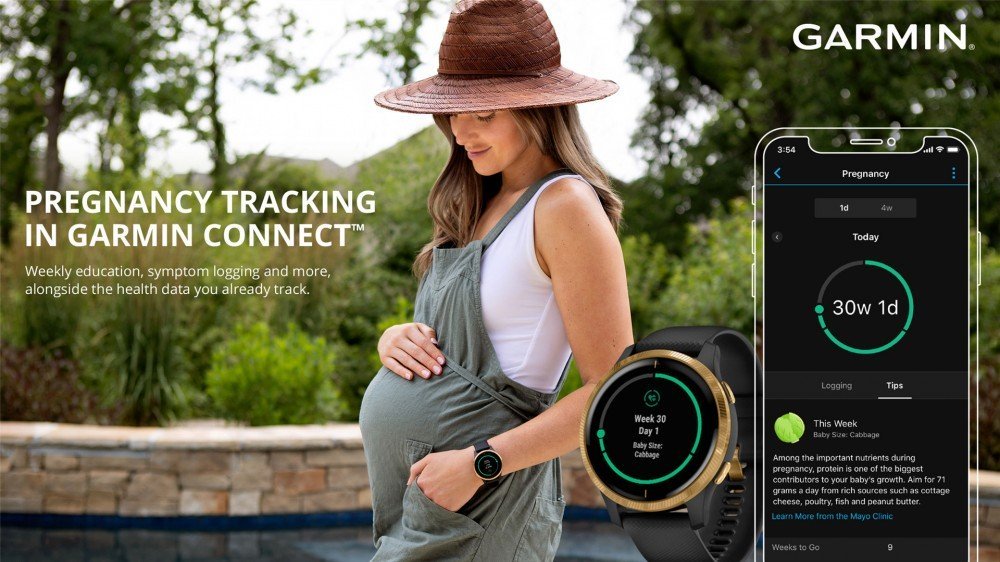 Une femme tient son ventre de femme enceinte en portant, euh, une barboteuse?  Sauteur?  Je ne sais pas ce que c'est.  Une montre Garmin et l'application Connect sont sur le côté montrant les nouvelles fonctionnalités de suivi de grossesse 