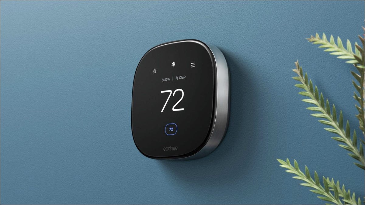 Un thermostat intelligent ecobee sur un mur bleu.