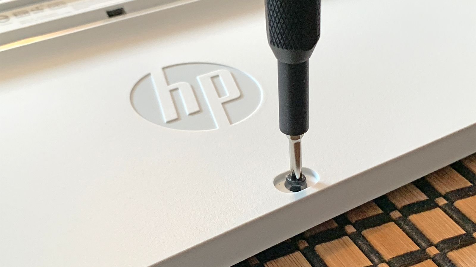 Un tournevis retirant une vis sur un clavier HP.