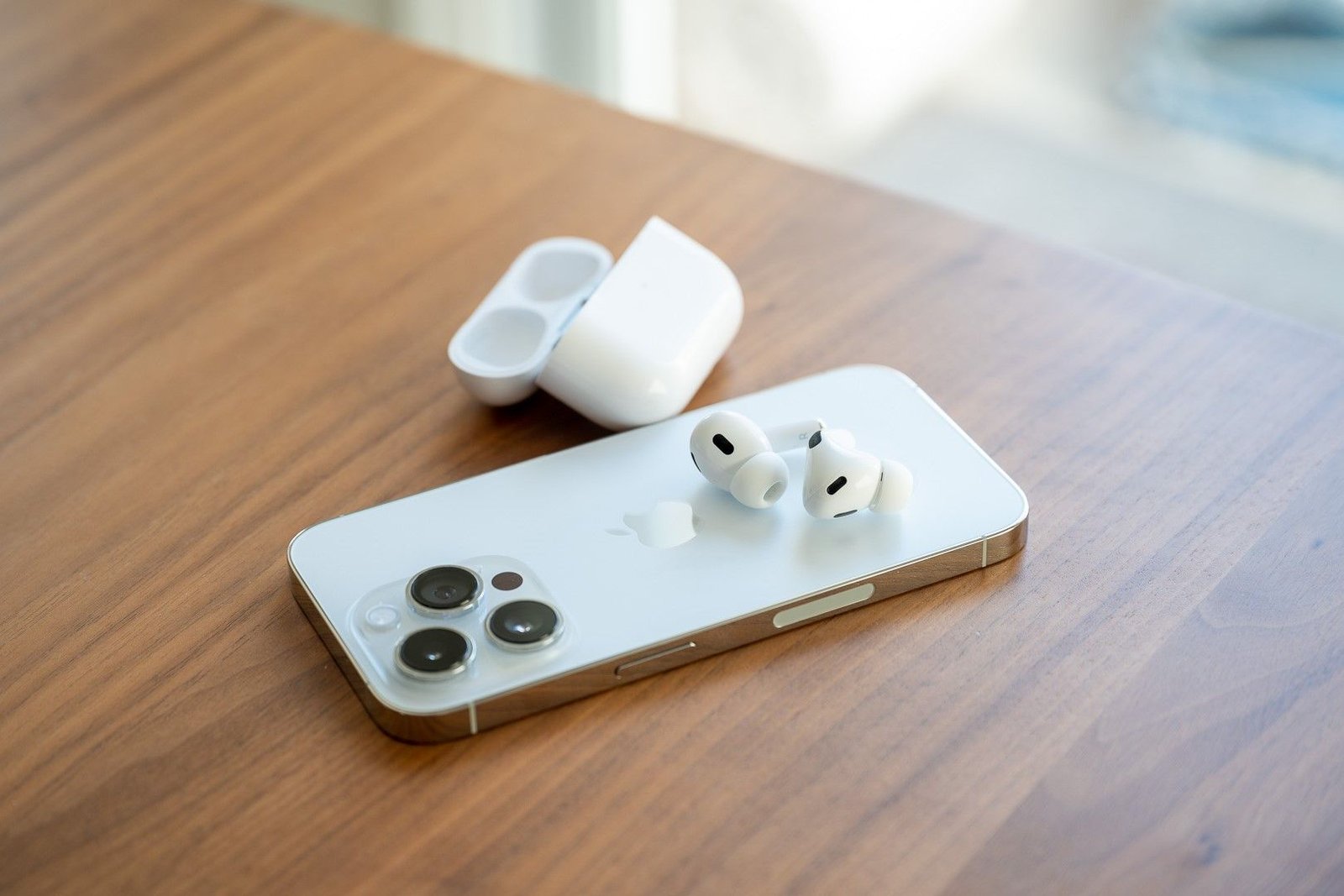 Apple AirPods Pro 2e génération posés à l'arrière de l'iPhone 14 Pro