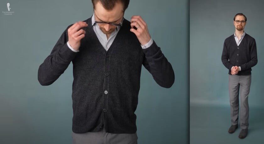 Preston portant une tenue masculine classique décontractée avec un cardigan bleu et gris, une chemise à motifs micro-grille, un pantalon gris, des chaussures en daim de Hinrich Dinkelacker et des chaussettes à rayures à deux tons de Fort Belvedere
