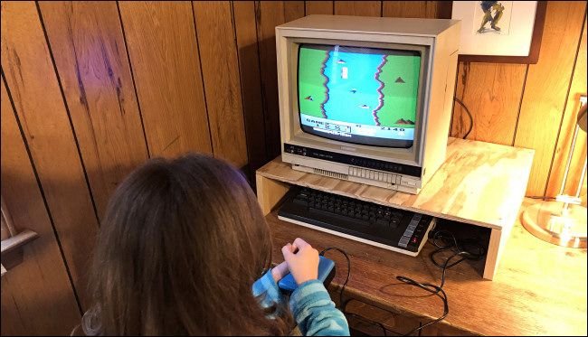 Un enfant jouant un raid River sur un ordinateur Atari 800xl.