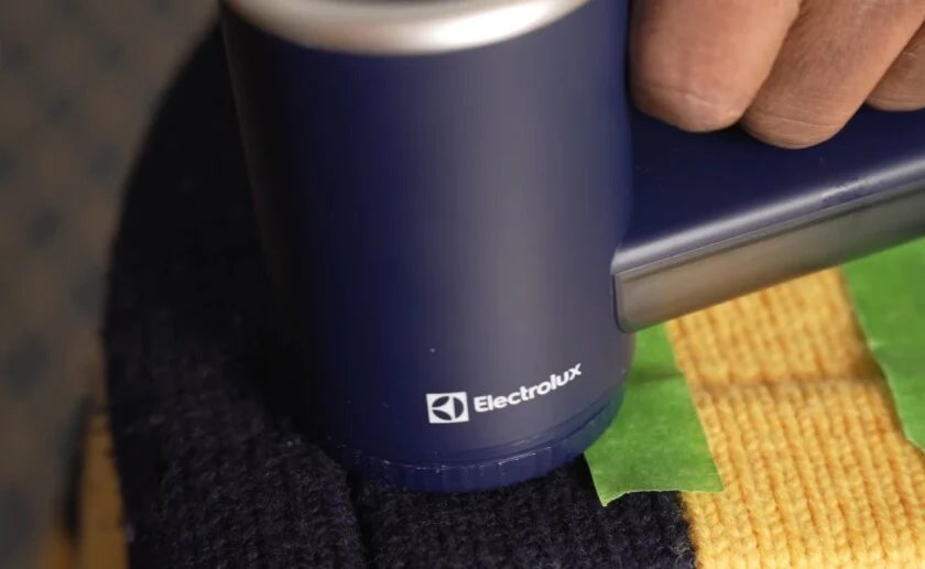 Rasoir à tissu électrique enlevant le pull en laine boulochée Rasoir électrique pour retirer les pilules d'un pull en laine lors d'un test de dépilling.